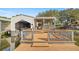 Exterior view of the boathouse on the water featuring a covered deck, boat lift, and a space for storage at 10900 Se Timucuan Rd, Summerfield, FL 34491