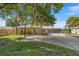 Inviting one-story home with a large front yard, screened garage, and charming architectural details at 10900 Se Timucuan Rd, Summerfield, FL 34491
