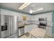 Bright kitchen features stainless steel appliances, granite countertops, and ample cabinet space at 10900 Se Timucuan Rd, Summerfield, FL 34491