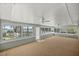 Bright sunroom with large windows, ceiling fans, and a view of the outdoor area at 10900 Se Timucuan Rd, Summerfield, FL 34491