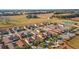 Aerial view of community, showcasing the layout and proximity to a field and a tennis court at 12312 Ne 48Th Loop, Oxford, FL 34484