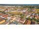 This aerial view highlights a well-planned residential community with diverse home styles and lush landscaping at 12312 Ne 48Th Loop, Oxford, FL 34484