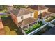 Aerial view of the home's backyard featuring a screened-in patio and landscaped yard at 12312 Ne 48Th Loop, Oxford, FL 34484