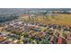 Expansive aerial view of a colorful residential neighborhood, showcasing the community's layout and surrounding greenery at 12312 Ne 48Th Loop, Oxford, FL 34484