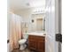 Bright bathroom features a shower-tub combo, single sink vanity, and neutral color palette at 12312 Ne 48Th Loop, Oxford, FL 34484