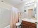 Neat bathroom featuring a vanity with a sink and cabinet, a toilet, and a shower-tub combination at 12312 Ne 48Th Loop, Oxford, FL 34484