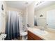 Bright bathroom features a shower-tub combo, single sink vanity, and neutral color palette at 12312 Ne 48Th Loop, Oxford, FL 34484