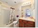 This full bathroom features a shower and single sink and provides entry into one of the bedrooms at 12312 Ne 48Th Loop, Oxford, FL 34484