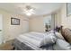 Comfortable bedroom featuring a large bed, carpet flooring, and a window with natural light at 12312 Ne 48Th Loop, Oxford, FL 34484