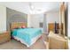 Well-lit bedroom with modern decor, and a large headboard and mirror on the side at 12312 Ne 48Th Loop, Oxford, FL 34484