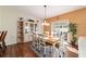 Cozy dining area with a classic hutch, seamless access to outdoor spaces, and a warm, inviting ambiance at 12312 Ne 48Th Loop, Oxford, FL 34484