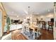 Open-concept dining area with stylish furniture, seamlessly connected to the living room and kitchen, ideal for gatherings at 12312 Ne 48Th Loop, Oxford, FL 34484
