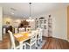 This dining area showcases an open floor plan with wood floors and an elegant display cabinet at 12312 Ne 48Th Loop, Oxford, FL 34484