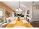 Elegant dining space features a large wood table, comfortable seating, and seamless flow to outdoor areas, perfect for entertaining at 12312 Ne 48Th Loop, Oxford, FL 34484