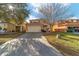 Two-story home with an attached two car garage, a concrete driveway and grass at 12312 Ne 48Th Loop, Oxford, FL 34484