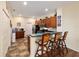 Eat-in kitchen with breakfast bar, wood cabinets, stainless steel appliances, and tile flooring at 12312 Ne 48Th Loop, Oxford, FL 34484