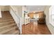 Open-concept living area with wood floors, stairs, modern décor, and ample natural light at 12312 Ne 48Th Loop, Oxford, FL 34484