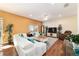 Open living room with a large sectional sofa, hardwood floors, and natural light at 12312 Ne 48Th Loop, Oxford, FL 34484