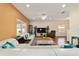 Open living room with a large sectional sofa, hardwood floors, and natural light at 12312 Ne 48Th Loop, Oxford, FL 34484