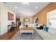 Spacious living room featuring a white couch, neutral paint and wood floors at 12312 Ne 48Th Loop, Oxford, FL 34484