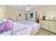 Serene main bedroom with soft lighting, neutral tones, and ensuite bathroom, creating a peaceful retreat at 12312 Ne 48Th Loop, Oxford, FL 34484