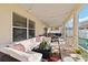 Relaxing screened patio offers comfortable seating, views of the backyard, and a peaceful outdoor living space at 12312 Ne 48Th Loop, Oxford, FL 34484