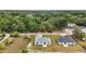 An aerial view of the property showing the home's location surrounded by lush trees and well manicured lawns at 13743 Sw 113 Ln, Dunnellon, FL 34432
