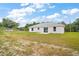 Large backyard features a well-maintained lawn and sliding glass doors that provide easy access to the home at 13743 Sw 113 Ln, Dunnellon, FL 34432