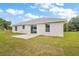 This home features a generously sized backyard, perfect for outdoor gatherings and relaxation on a concrete patio at 13743 Sw 113 Ln, Dunnellon, FL 34432