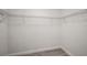 Walk-in closet features a wire shelving system and modern gray floors at 13743 Sw 113 Ln, Dunnellon, FL 34432