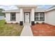 Charming home featuring a covered entry way, complemented by a well-maintained front yard at 13743 Sw 113 Ln, Dunnellon, FL 34432
