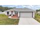Beautiful one-story home featuring a two-car garage, concrete driveway, and modern landscaping at 13743 Sw 113 Ln, Dunnellon, FL 34432