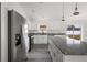Bright kitchen with white cabinets, stainless steel appliances, and a large island with granite countertops at 13743 Sw 113 Ln, Dunnellon, FL 34432