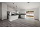 Open-concept kitchen with white cabinets, stainless steel appliances, and a sliding glass door at 13743 Sw 113 Ln, Dunnellon, FL 34432