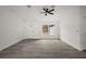 Bright living room featuring gray flooring, a ceiling fan, and white trim throughout at 13743 Sw 113 Ln, Dunnellon, FL 34432