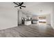 A spacious, open-concept living room with gray wood-look flooring at 13743 Sw 113 Ln, Dunnellon, FL 34432