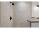 Shower with marble style tile surround and black shower head at 13743 Sw 113 Ln, Dunnellon, FL 34432