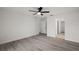 Bedroom with wood look floors, closet, and door to the hallway at 13757 Sw 113 Ln, Dunnellon, FL 34432