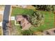 Aerial view showcasing the home's layout and expansive green lawn with defined property lines at 13779 Sw 115Th Cir, Dunnellon, FL 34432