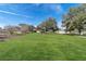 Expansive backyard features a lush lawn and mature trees, offering a serene and private outdoor space at 13779 Sw 115Th Cir, Dunnellon, FL 34432