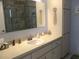 Bathroom featuring a large mirror, vanity with sink, and glass-enclosed shower at 13779 Sw 115Th Cir, Dunnellon, FL 34432