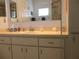 Bathroom featuring a large mirror, vanity with sink, and linen cabinet at 13779 Sw 115Th Cir, Dunnellon, FL 34432