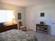 Bright bedroom with tile flooring, a wooden bookshelf and a comfortable chair at 13779 Sw 115Th Cir, Dunnellon, FL 34432