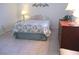 Bedroom with tile flooring, floral bedding, and a wooden dresser at 13779 Sw 115Th Cir, Dunnellon, FL 34432