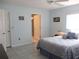Bedroom with blue accents, ceiling fan, and tile flooring with an ensuite bathroom at 13779 Sw 115Th Cir, Dunnellon, FL 34432
