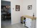 Dining area with a white storage cabinet, seamlessly connecting to a dining room with chandelier, and a living area at 13779 Sw 115Th Cir, Dunnellon, FL 34432