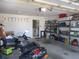 Functional garage offering storage shelves, room for a motorcycle, and an entrance to the laundry area at 13779 Sw 115Th Cir, Dunnellon, FL 34432
