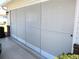 Enclosed garage featuring retractable screens for added privacy and enhanced outdoor experience at 13779 Sw 115Th Cir, Dunnellon, FL 34432