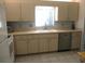 Bright kitchen featuring light cabinets, white appliances, and neutral countertops at 13779 Sw 115Th Cir, Dunnellon, FL 34432