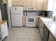 Functional kitchen with white appliances, light wood cabinets, and ample counter space for meal preparation at 13779 Sw 115Th Cir, Dunnellon, FL 34432